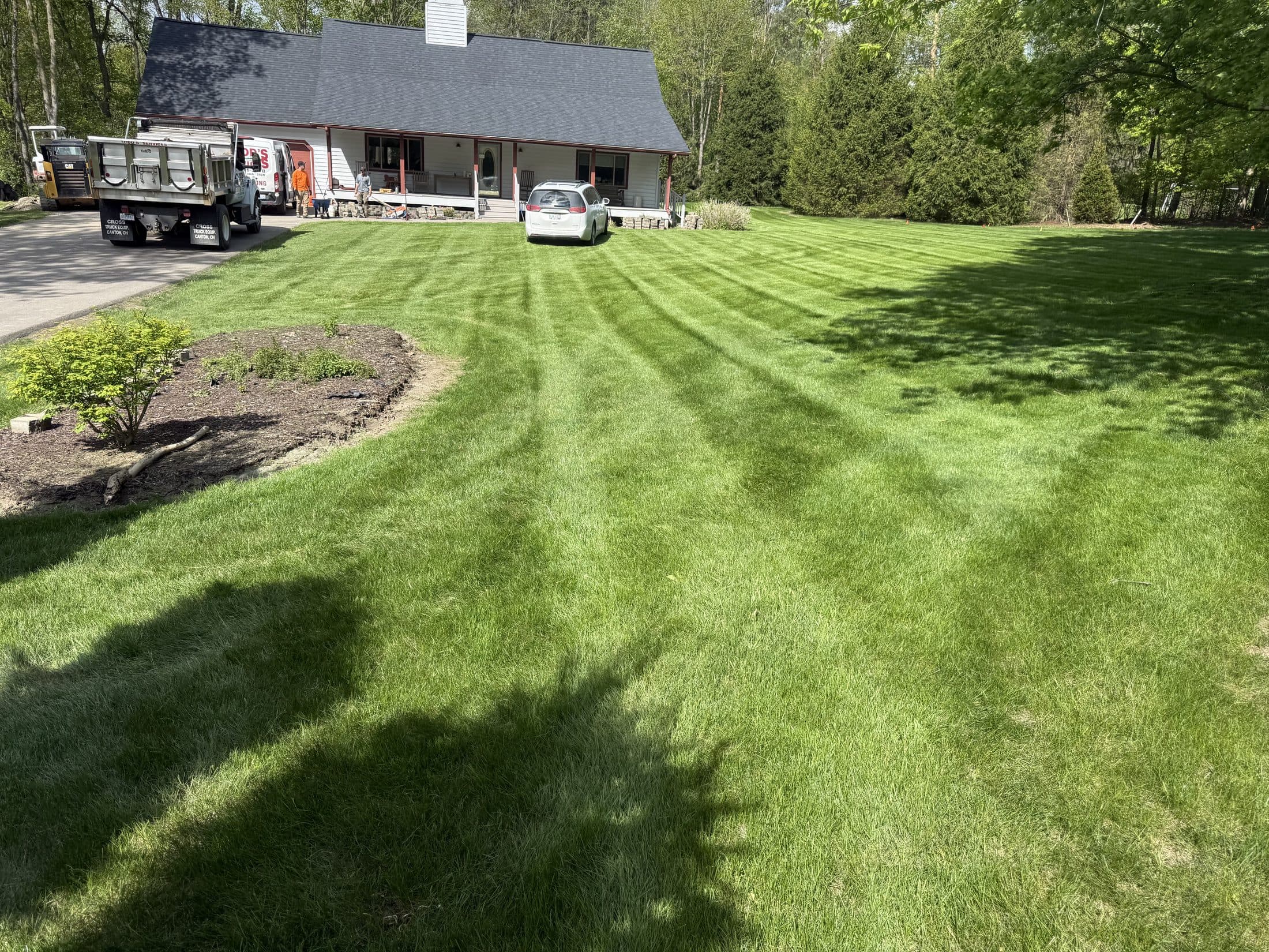The Jaws work truck parked at a home with a freshly striped front lawn