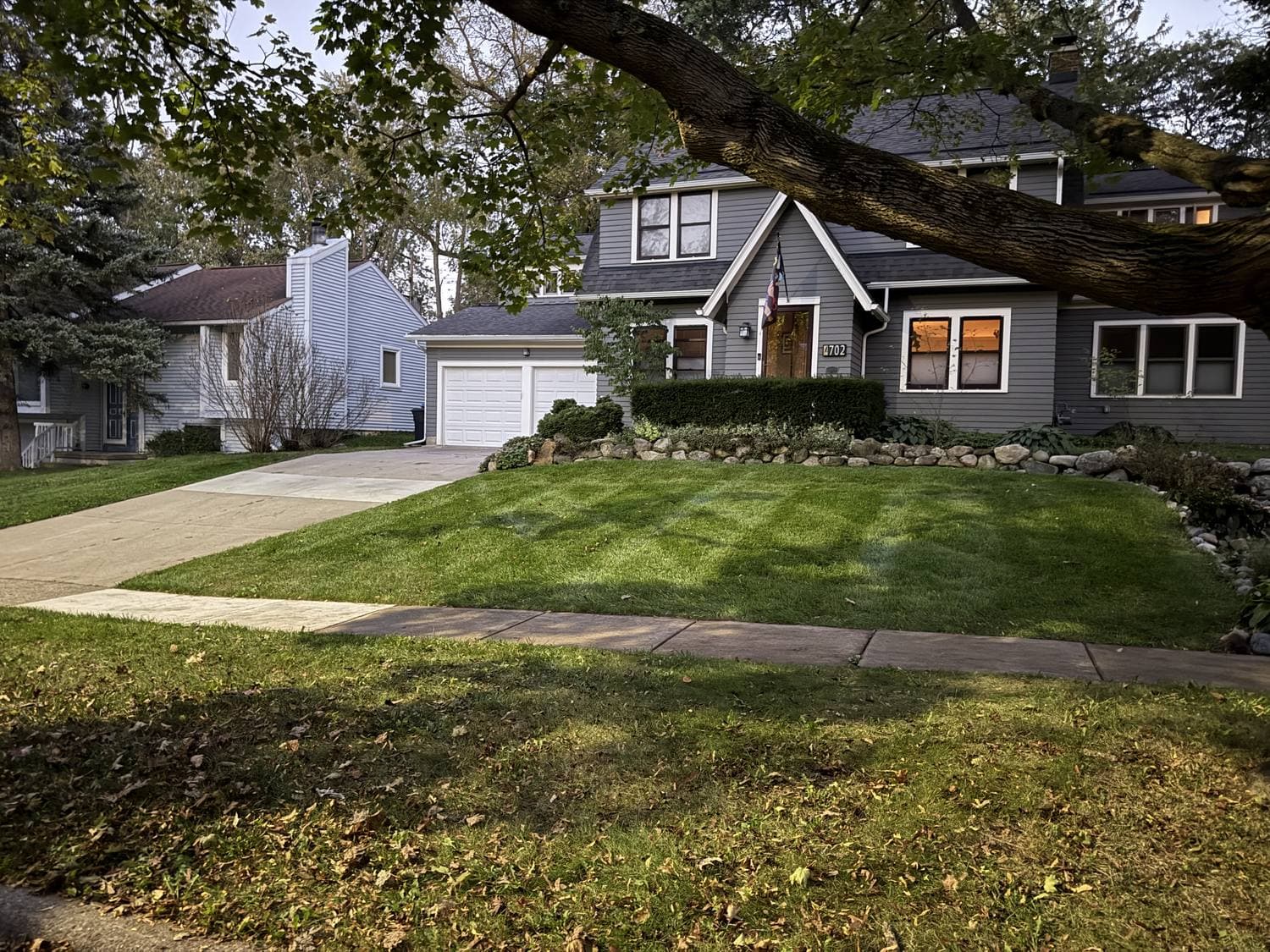 Foundation plantings and mulched beds framing a freshly striped front lawn